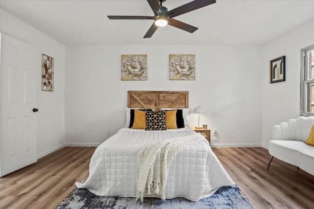 bedroom with ceiling fan and hardwood / wood-style flooring