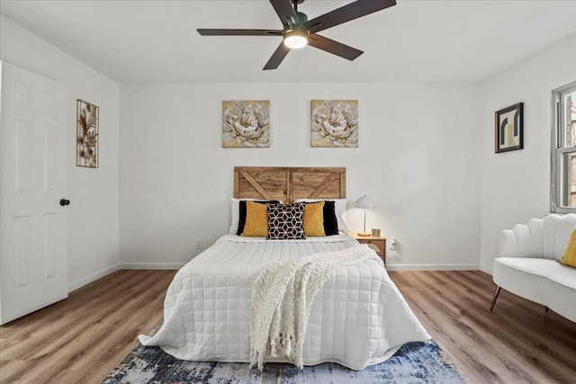 bedroom with ceiling fan and wood-type flooring