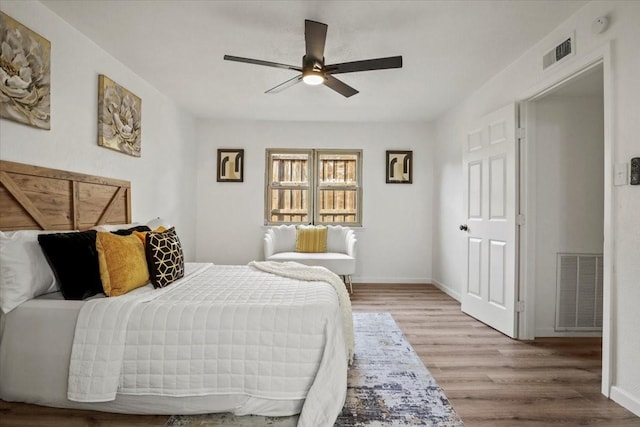 bedroom with wood-type flooring and ceiling fan