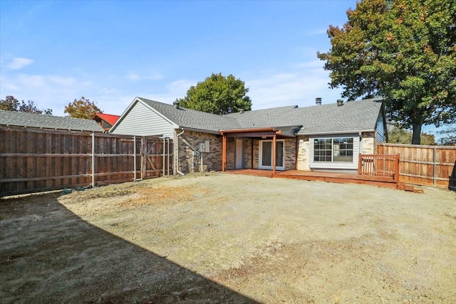 back of property with a wooden deck