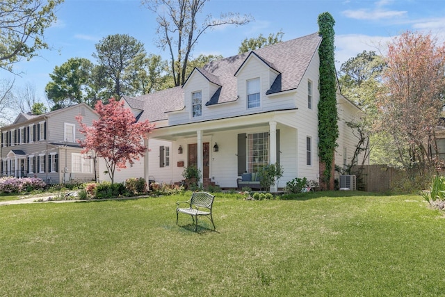 cape cod-style house featuring cooling unit, a front lawn, and a porch