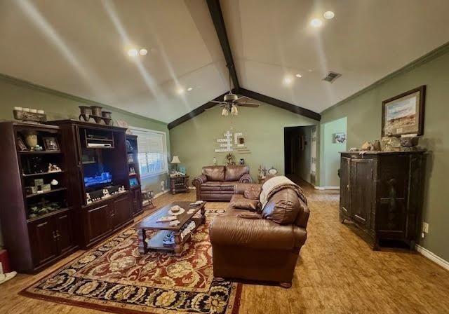 living room featuring ceiling fan, lofted ceiling with beams, and light wood-type flooring