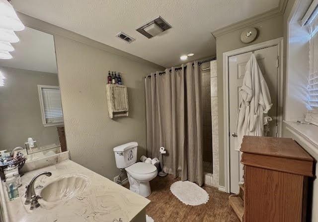 bathroom with walk in shower, hardwood / wood-style floors, vanity, and toilet