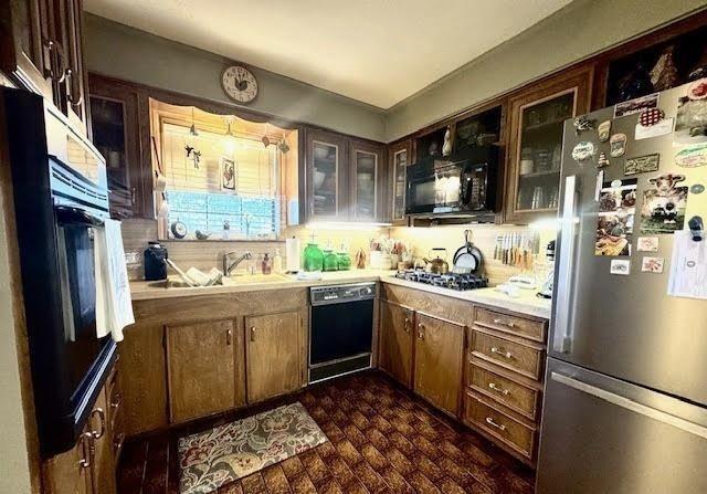 kitchen featuring sink and black appliances