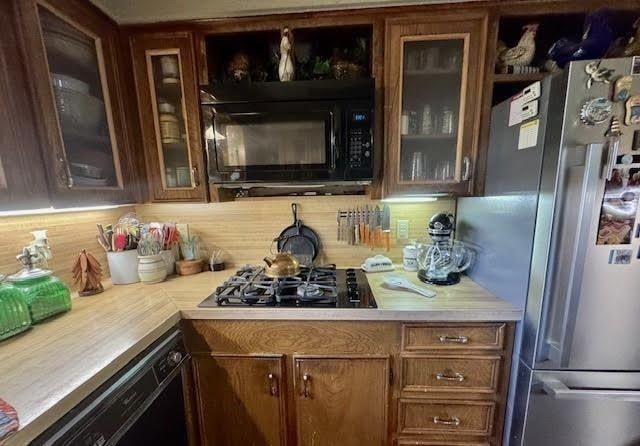 kitchen with black appliances and tasteful backsplash