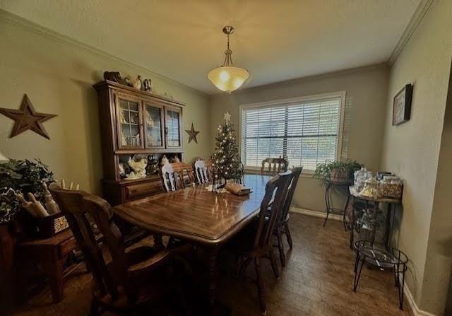 dining space with dark hardwood / wood-style floors and crown molding