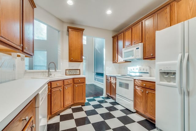 kitchen with sink, white appliances, and backsplash