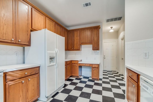 kitchen with white appliances and backsplash