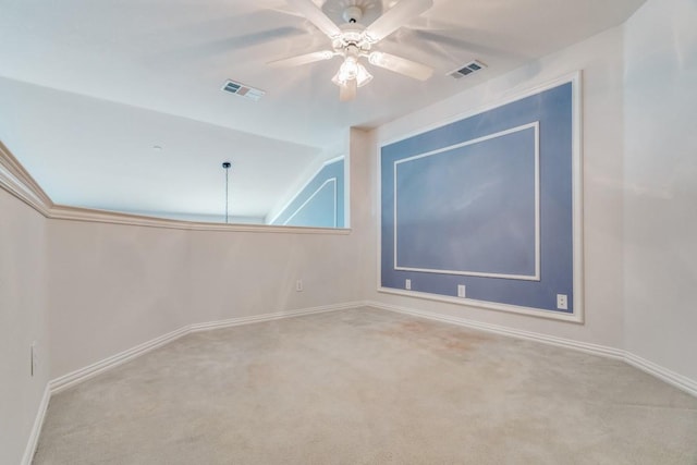 carpeted spare room with ceiling fan and lofted ceiling