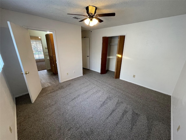 unfurnished bedroom with visible vents, baseboards, carpet floors, a closet, and a textured ceiling