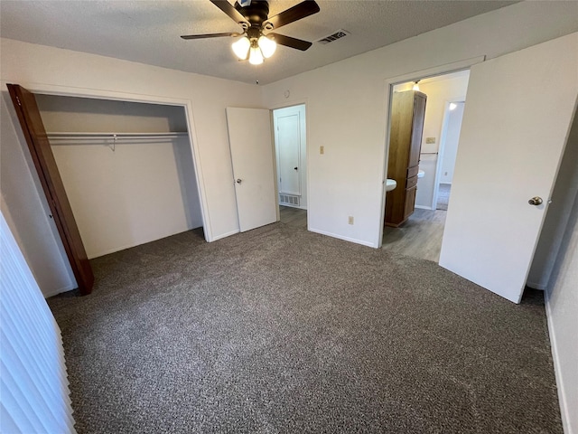 unfurnished bedroom with visible vents, carpet floors, a textured ceiling, and a closet