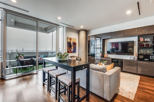 living room with expansive windows and dark hardwood / wood-style flooring