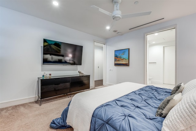 bedroom with connected bathroom, ceiling fan, and light colored carpet