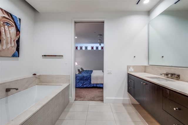 bathroom with tiled bath, tile patterned flooring, and vanity