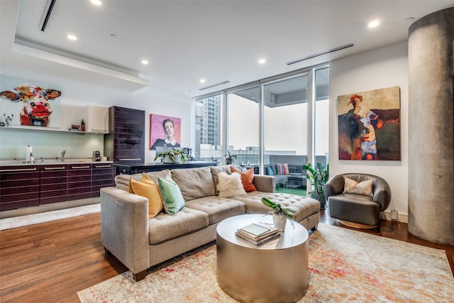 living room with hardwood / wood-style flooring and floor to ceiling windows