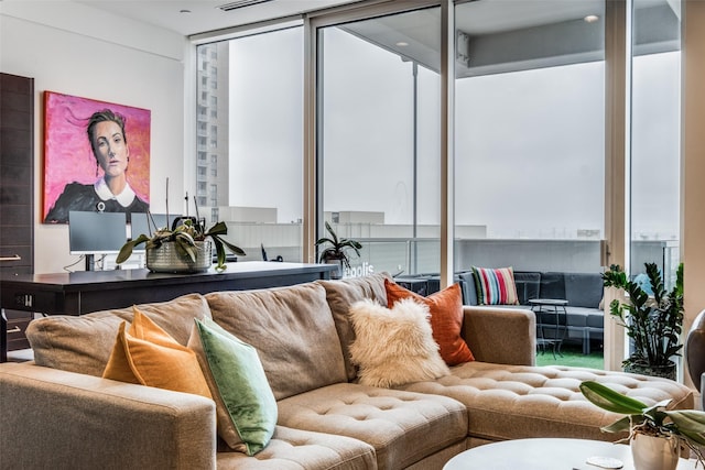 living room with expansive windows and a wealth of natural light