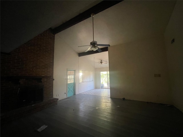 unfurnished living room with ceiling fan, beam ceiling, high vaulted ceiling, a fireplace, and wood-type flooring