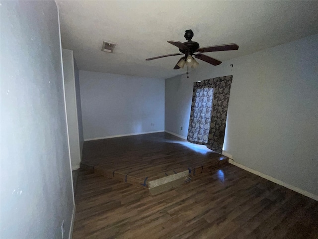 unfurnished room featuring dark hardwood / wood-style floors and ceiling fan