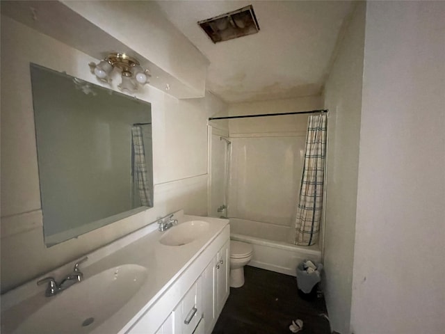 full bathroom featuring vanity, shower / bathtub combination with curtain, and toilet