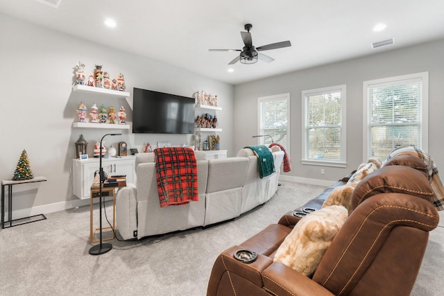 living room featuring ceiling fan and light colored carpet