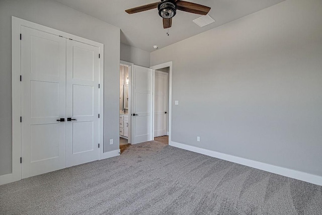 unfurnished bedroom with ceiling fan, light colored carpet, connected bathroom, and a closet