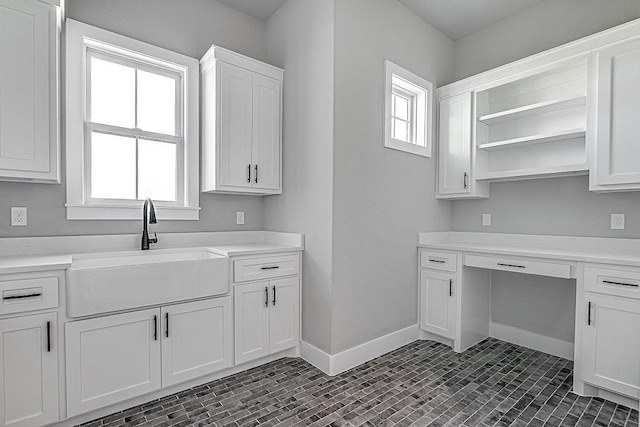 kitchen with white cabinetry and sink