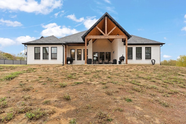 rear view of house with a yard