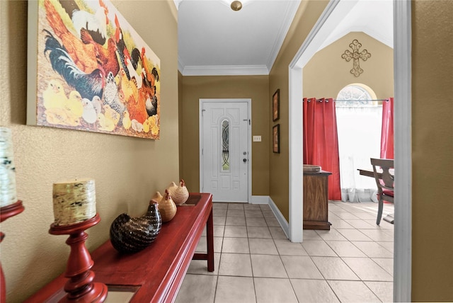 foyer with light tile patterned flooring, crown molding, and vaulted ceiling