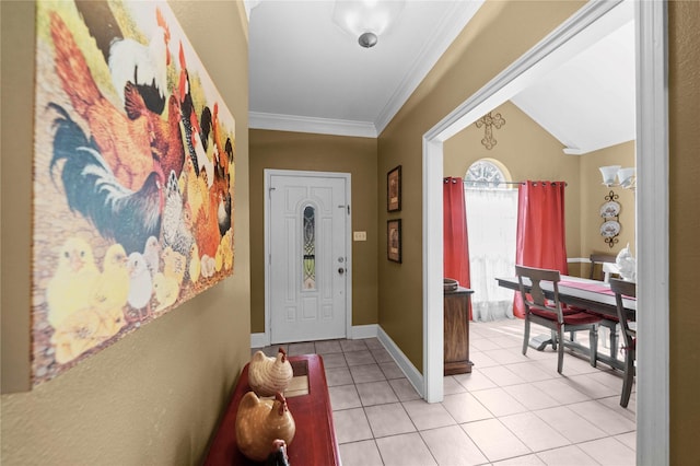 entrance foyer with ornamental molding, light tile patterned floors, and lofted ceiling