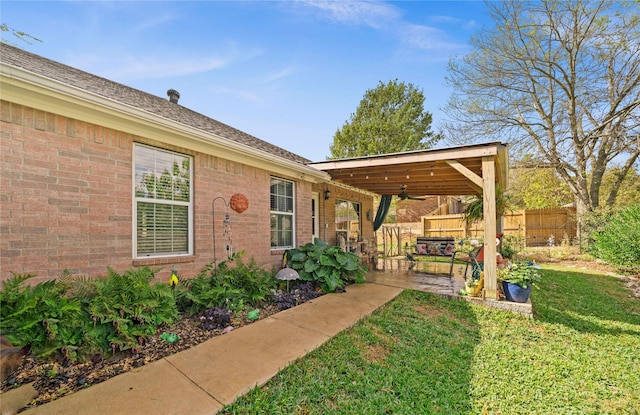 view of yard with ceiling fan and a patio