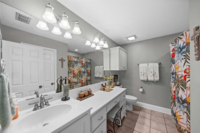 bathroom with tile patterned flooring, vanity, curtained shower, and toilet