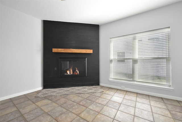 unfurnished living room with a large fireplace