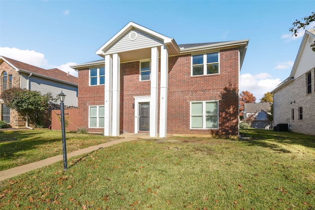 view of front of home with central AC and a front lawn