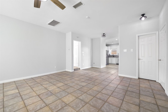 unfurnished living room with ceiling fan