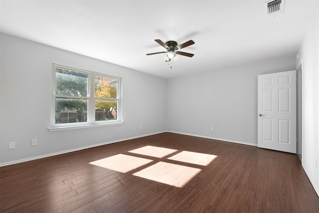 empty room with ceiling fan and dark hardwood / wood-style flooring