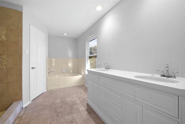 bathroom with a tub to relax in and vanity