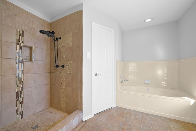 bathroom featuring shower with separate bathtub