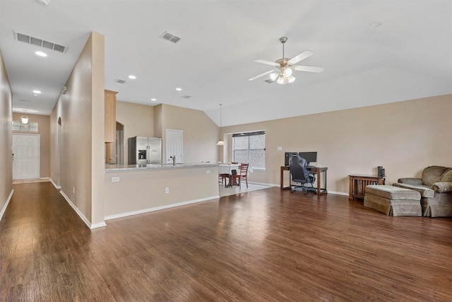 living room featuring dark hardwood / wood-style floors, ceiling fan, and vaulted ceiling