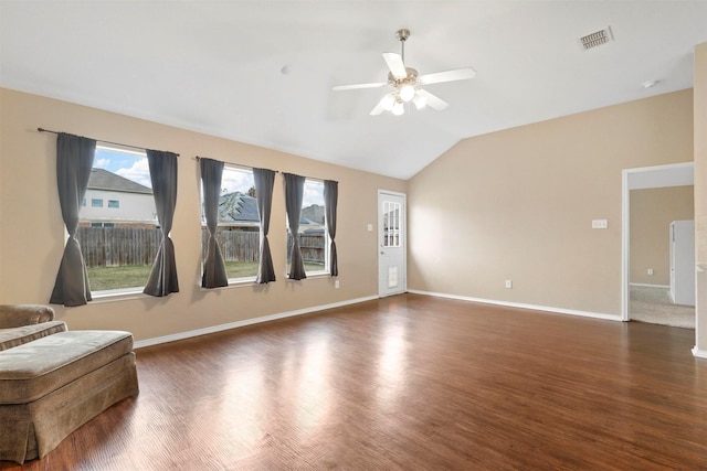 unfurnished living room featuring dark hardwood / wood-style floors, ceiling fan, a healthy amount of sunlight, and vaulted ceiling