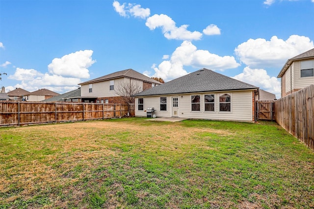 rear view of property with a patio area and a yard