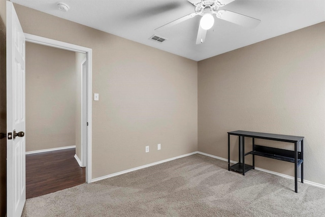 empty room with ceiling fan and carpet