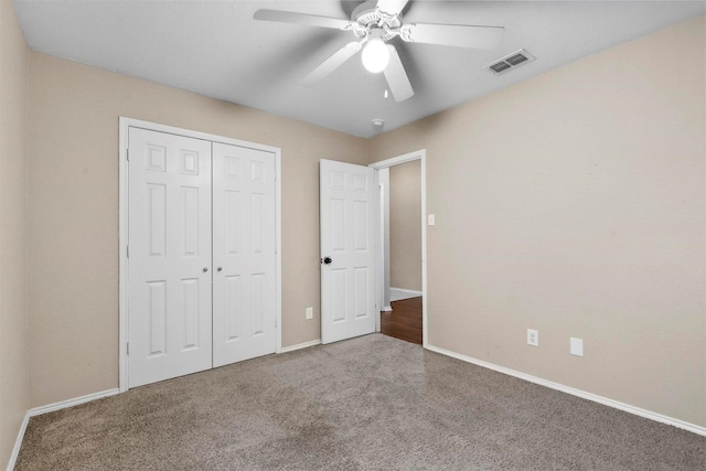 unfurnished bedroom with ceiling fan, a closet, and carpet floors