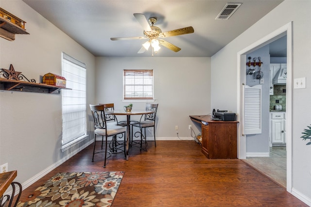 dining area featuring ceiling fan and dark hardwood / wood-style flooring