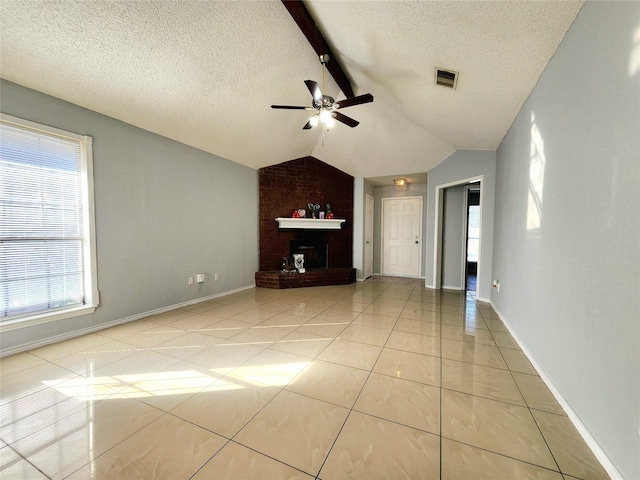 unfurnished living room featuring ceiling fan, light tile patterned floors, a textured ceiling, and vaulted ceiling