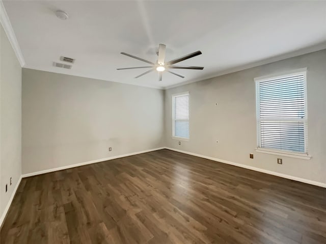 unfurnished room with crown molding, dark hardwood / wood-style floors, and ceiling fan