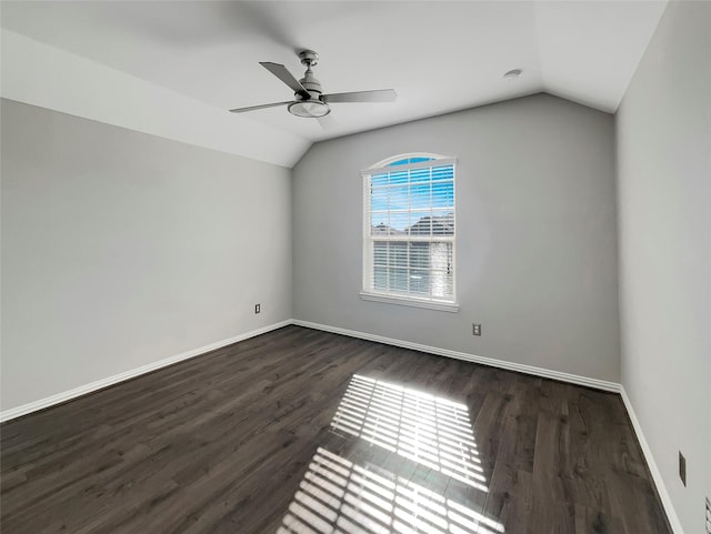 unfurnished room with lofted ceiling, dark hardwood / wood-style floors, and ceiling fan