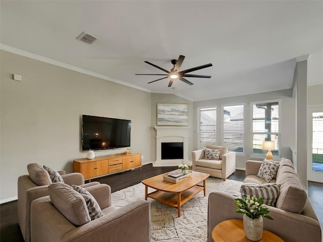 living room featuring ceiling fan, ornamental molding, lofted ceiling, and light wood-type flooring