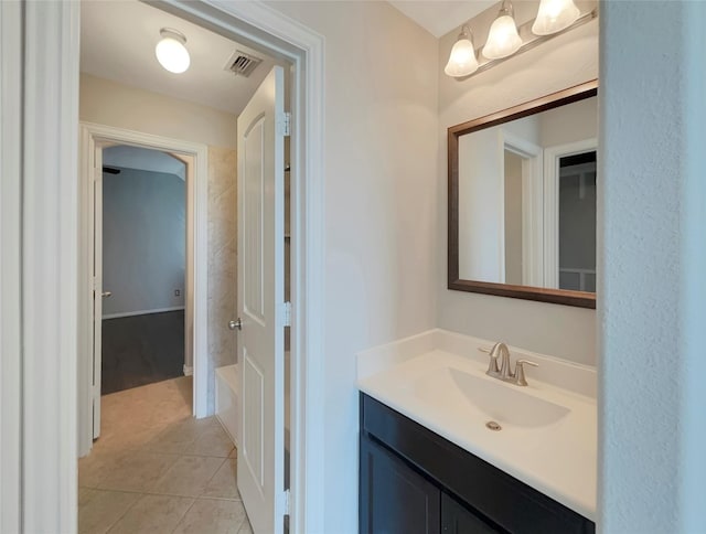 bathroom featuring vanity, a bathtub, and tile patterned floors