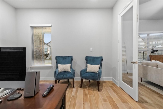 sitting room with hardwood / wood-style floors and french doors