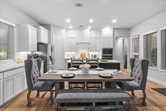 dining space with light hardwood / wood-style flooring